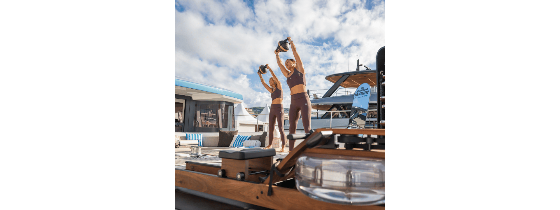 Participants exercising with hand weights on deck